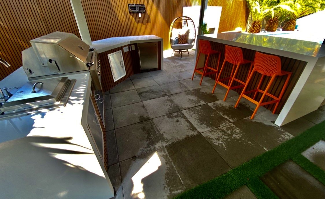 A patio with an orange chair and table