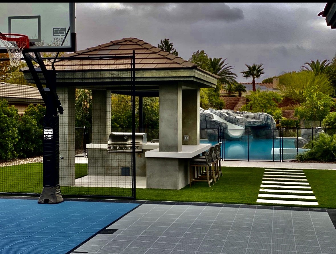 A pool with a basketball court and a gazebo