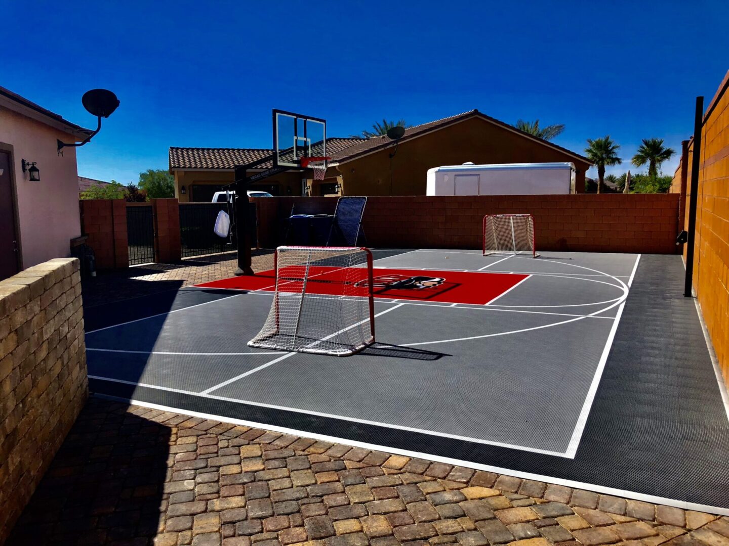 A basketball court with a net and a basket ball hoop.
