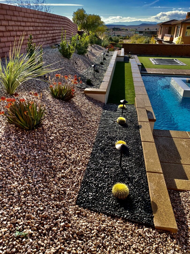 A pool area with a small garden and a water feature.