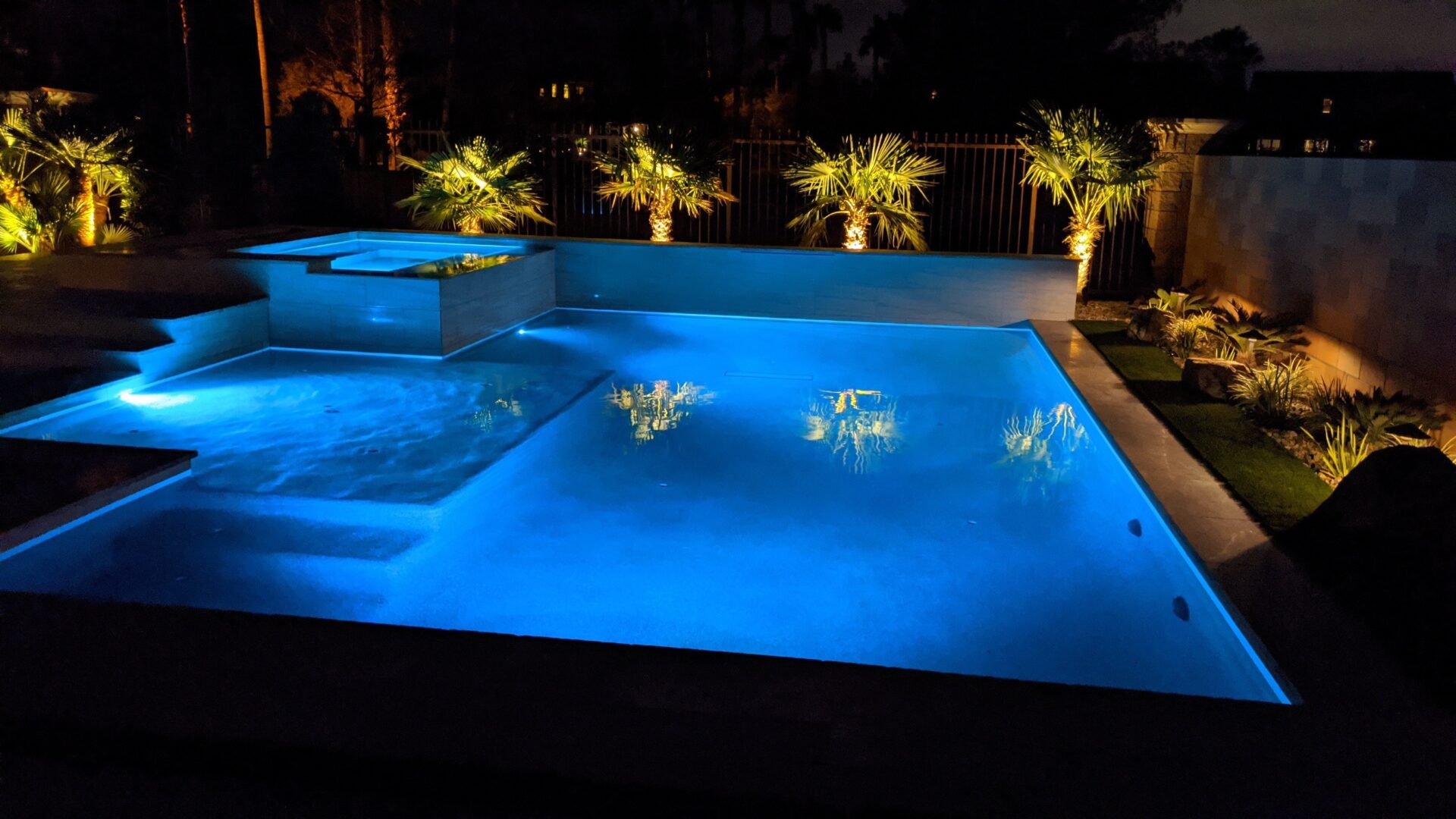 A pool with lights on the side of it