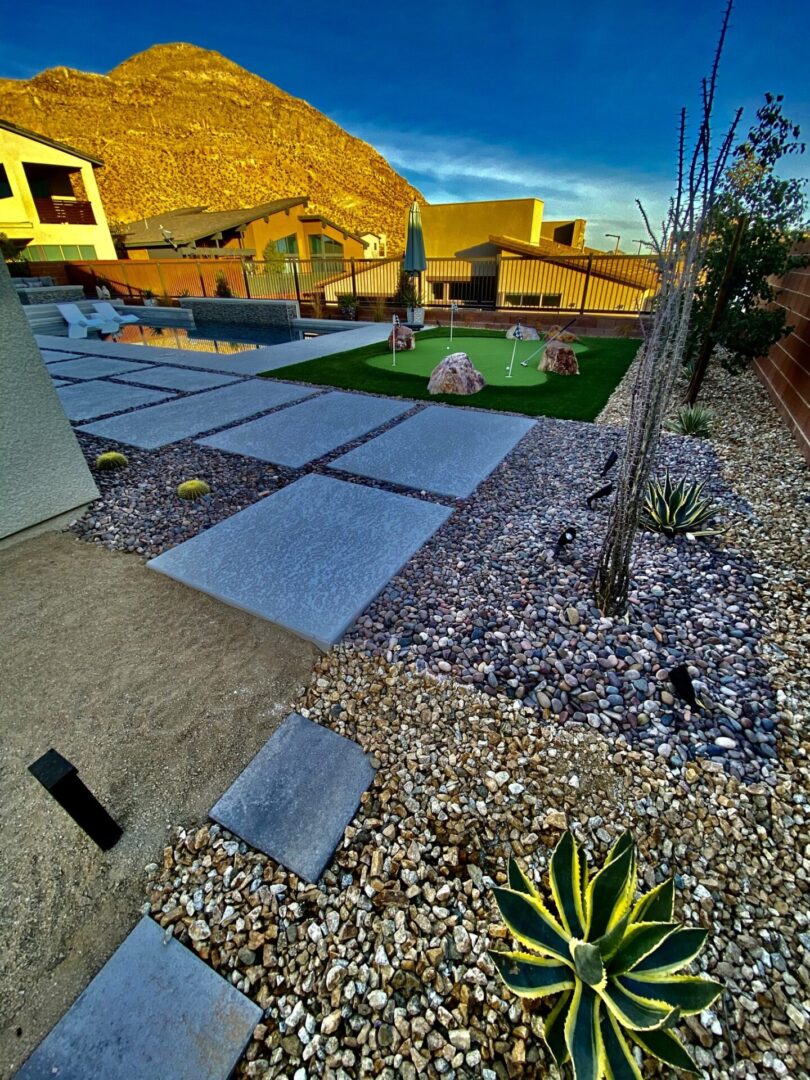 A backyard with a small garden and a rock wall.