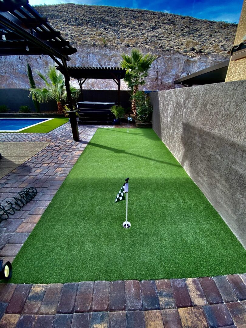 A backyard with a golf course and pool.