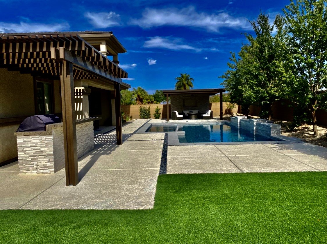 A pool with an outdoor area and patio