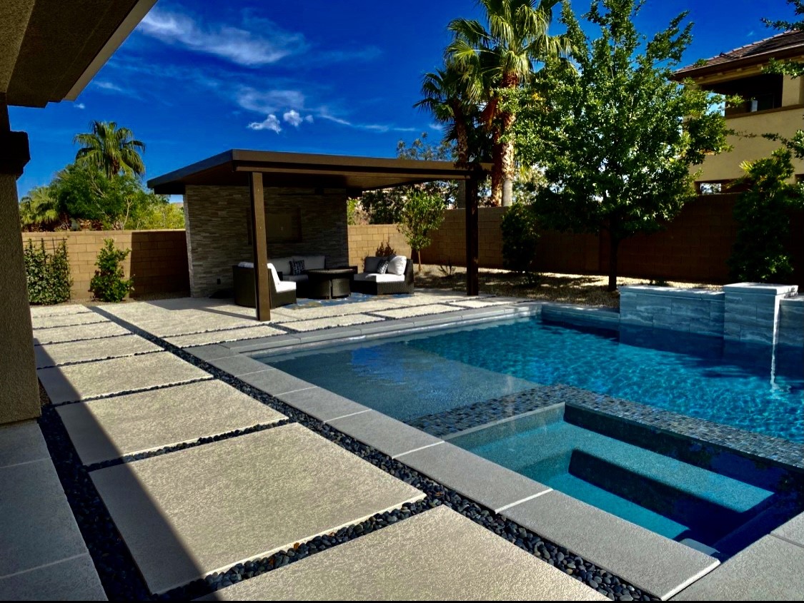 A pool with a covered area and patio.