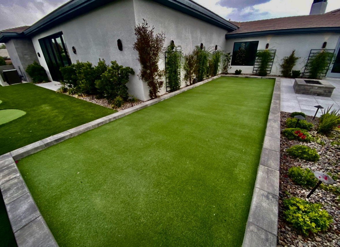 A yard with grass and concrete in the middle of it.