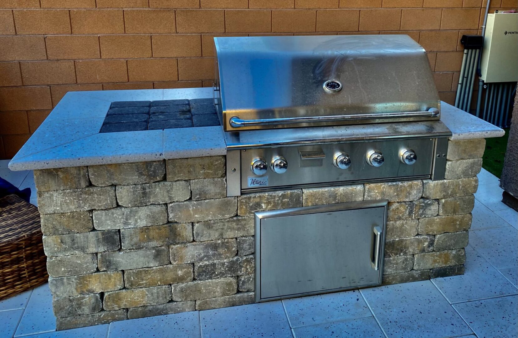 A grill with an open door and a built in bbq.