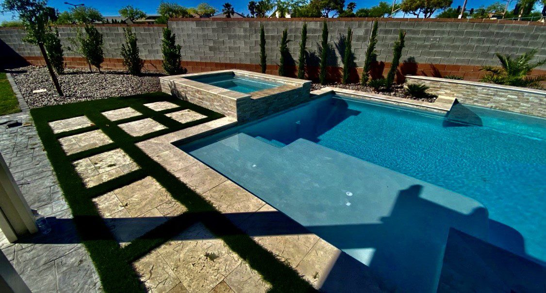 A pool with a stone wall and a brick wall