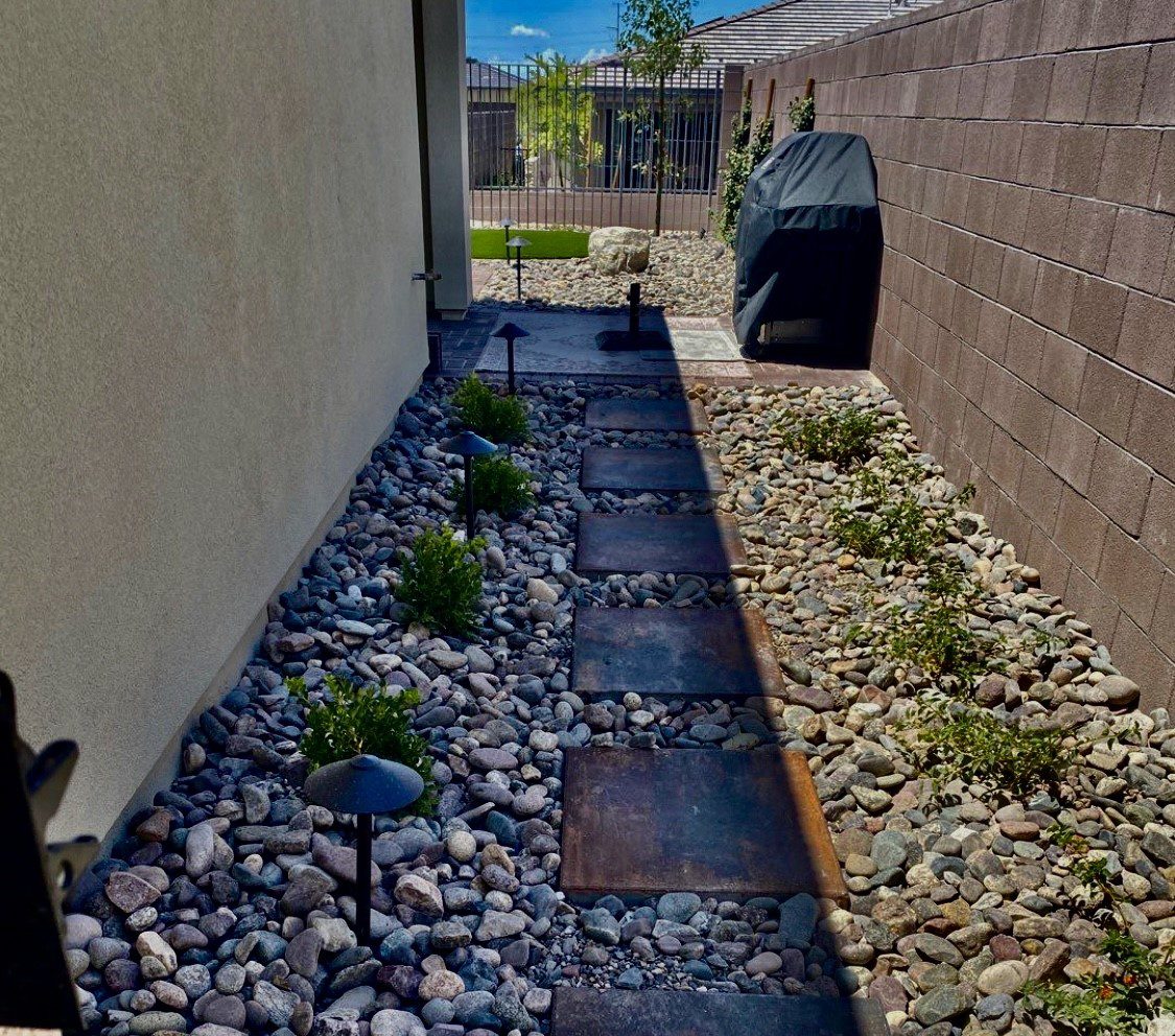 A walkway with stepping stones and rocks in the middle of it.