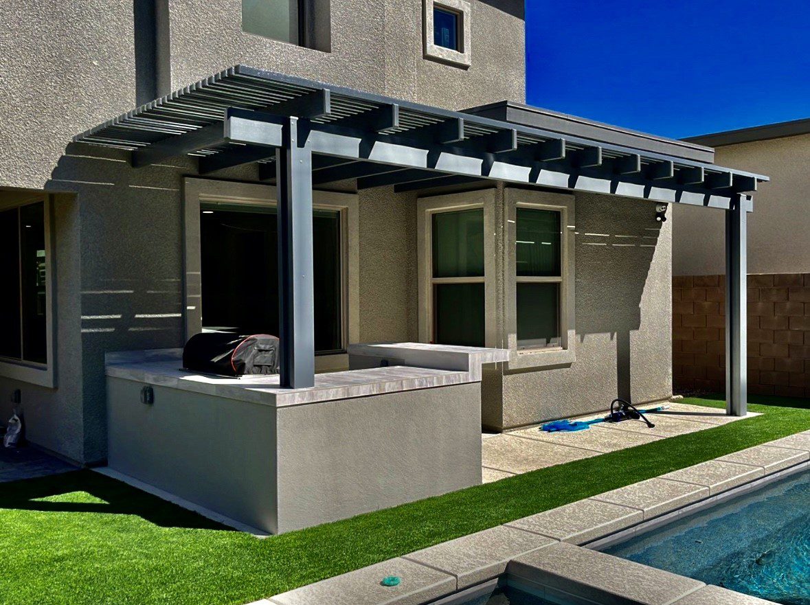 A patio cover with an outdoor grill and pool.
